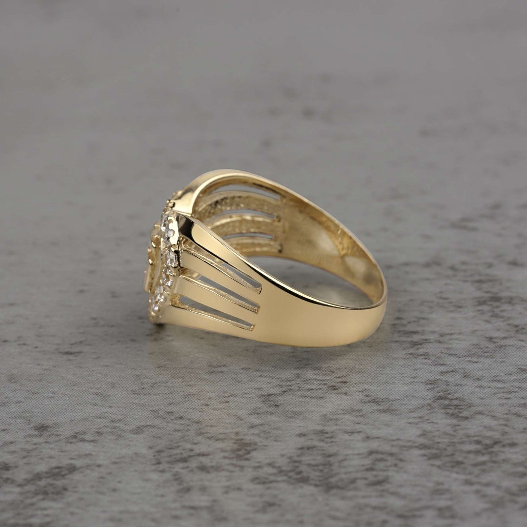 10k - 14k Gold ring with heart design and Cubic Zirconia side view on a gray surface