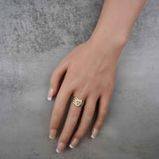 hand wearing a 10k - 14k heart shape gold ring with number 16 design.
