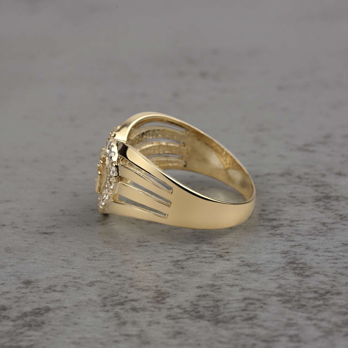 10k - 14k gold ring with cubic zirconia accents on a gray surface