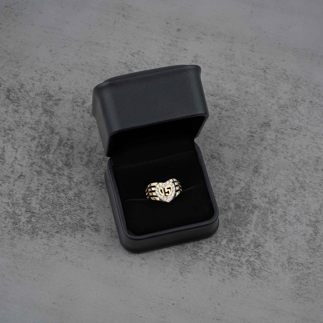 10k - 14k gold ring with a heart and number 15 design in an open black jewelry box 