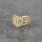 10k - 14k gold ring with number 15 and heart design on a gray background