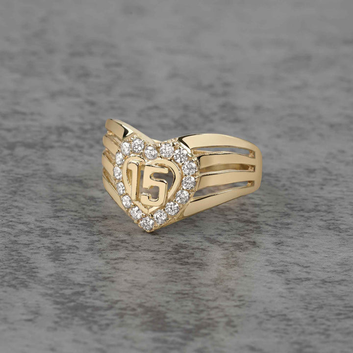 10k - 14k gold ring with number 15 and heart design on a gray background