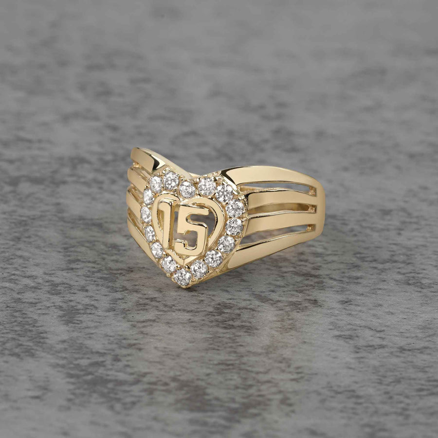 10k - 14k gold ring with number 15 and heart design on a gray background