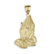 Back view of a yellow gold praying hands pendant on white background.