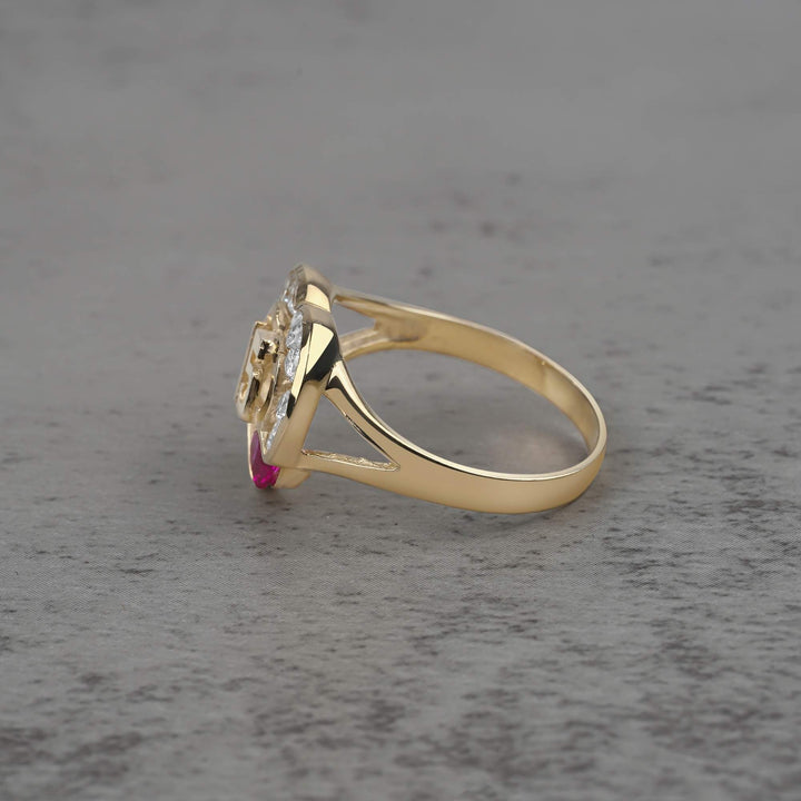 10k - 14k quinceañera gold ring with a cubic zirconia on a gray surface