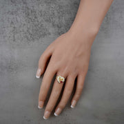 Hand wearing a 10k - 14k Quinceanera ring with a number 15 on a gray background