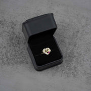 10k - 14k Gold ring with a heart design in a black jewelry box on a gray surface