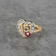 10k - 14k Gold ring with heart design and number 15 on a gray background