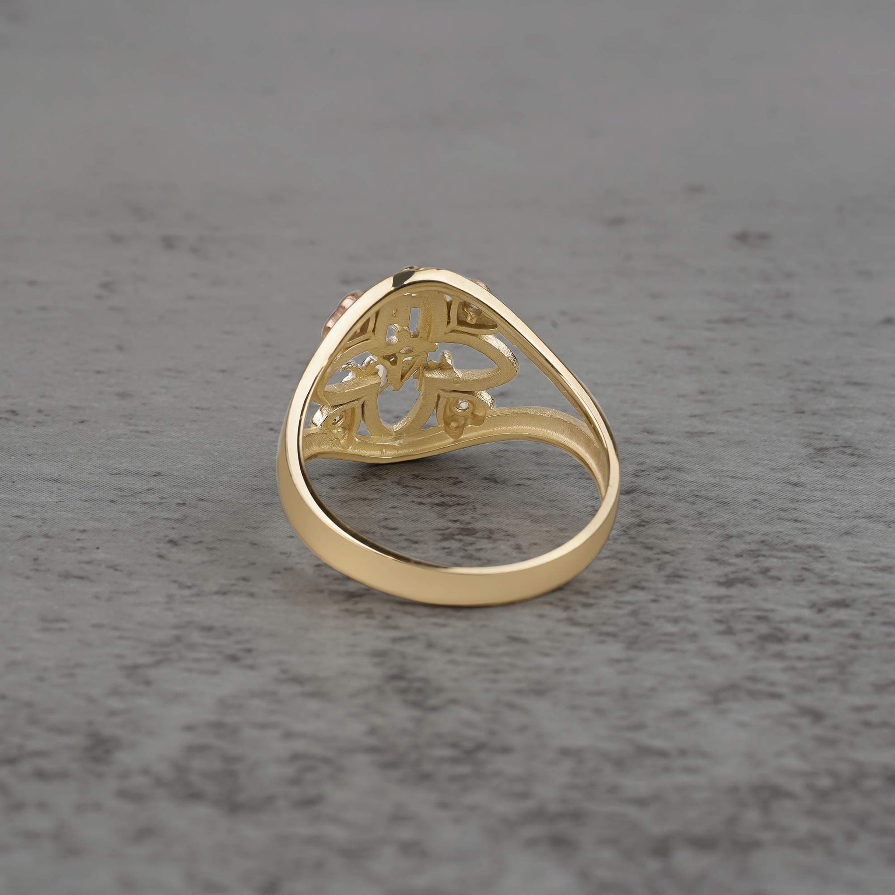 10k - 14k Gold ring with floral design  back view on a gray surface