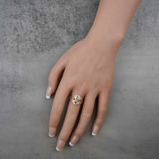 Hand wearing a 10k - 14k tricolor gold ring with a 15 anos engraving design 