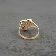 10k - 14k gold ring with a red cubic zirconia back view on a gray surface