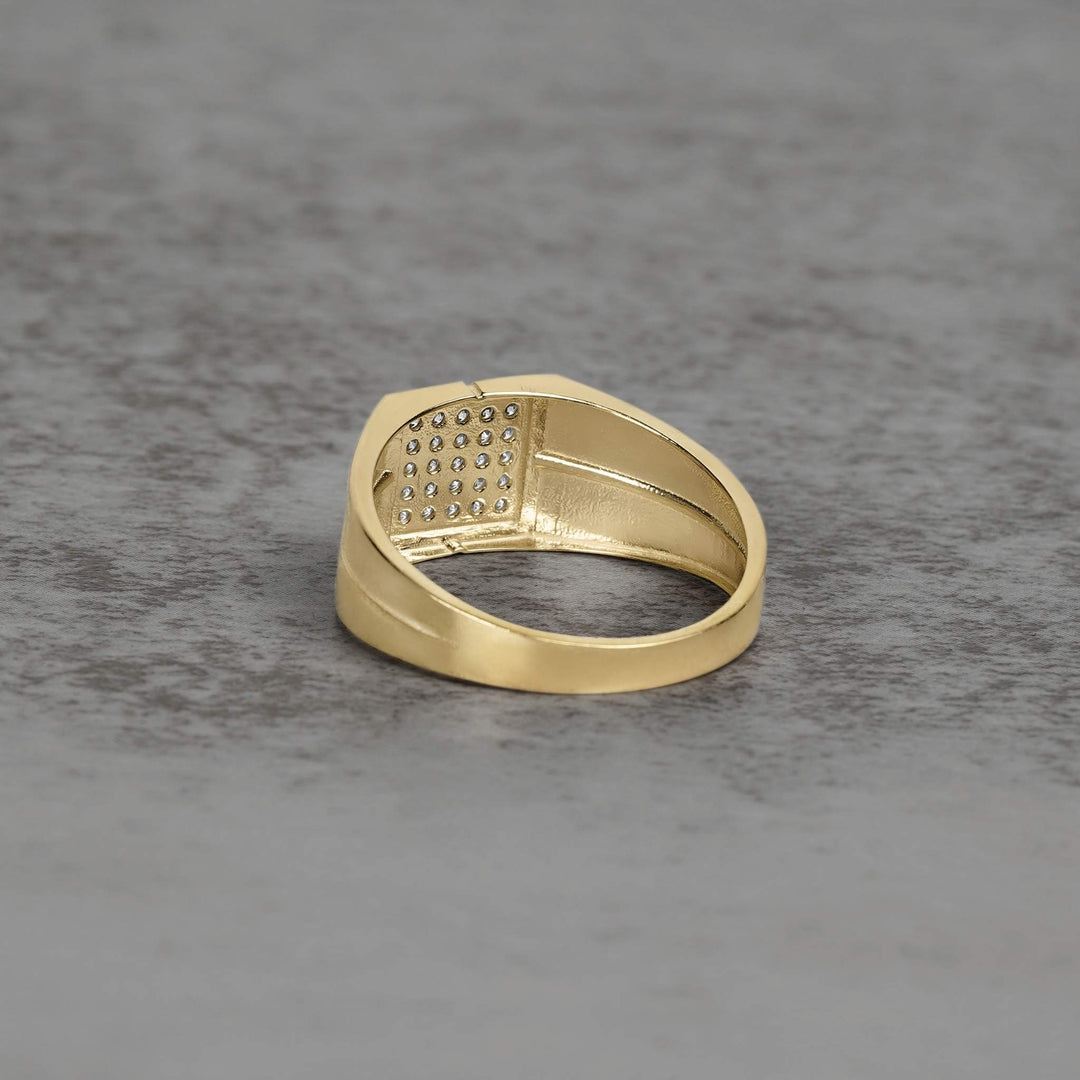 Reverse view of a gold square ring band revealing the textured under-gallery design.
