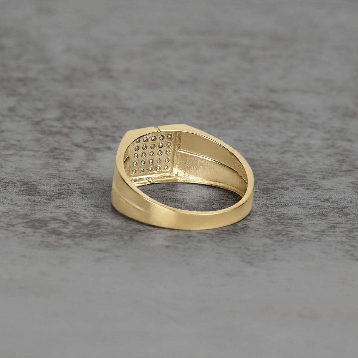 Reverse view of a gold square ring band revealing the textured under-gallery design.