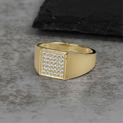 Classic gold signet ring with a flat square head encrusted with clear cubic zirconia.