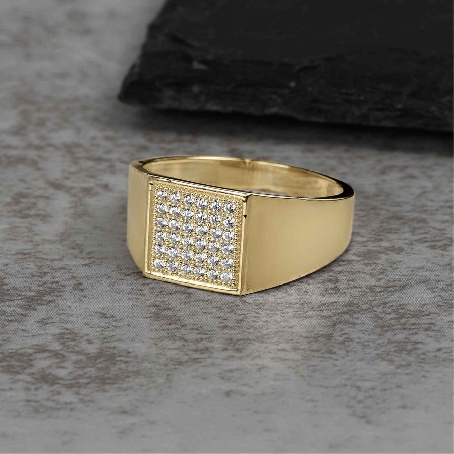 Classic gold signet ring with a flat square head encrusted with clear cubic zirconia.