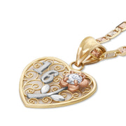 Detailed angle view of a multi-tone gold filigree heart charm with cubic zirconia.
