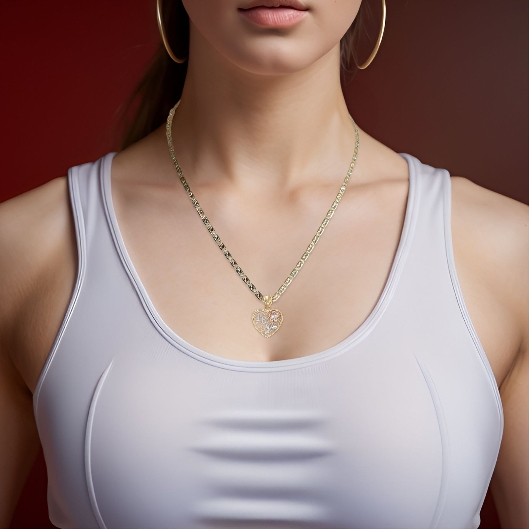 Woman wearing a tri-color gold Sweet 16 heart pendant necklace with a white tank top.