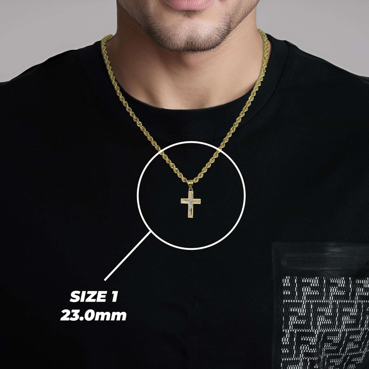Man wearing a gold crucifix cross pendant necklace labeled Size 1 23.0mm.