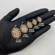 Gloved hand displaying five sizes of tri-color gold Virgin Mary pendant charms from X Small to X Large.