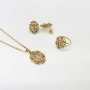 Tri-color gold Virgin Mary jewelry set featuring matching pendant necklace, ring, and stud earrings.