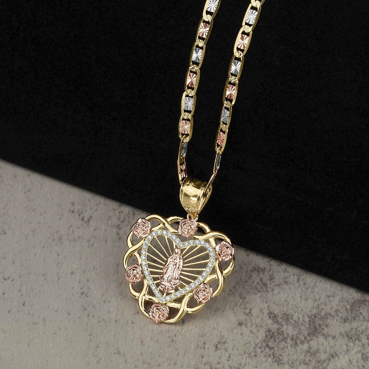Two-tone heart pendant with Our Lady of Guadalupe and a gold chain.