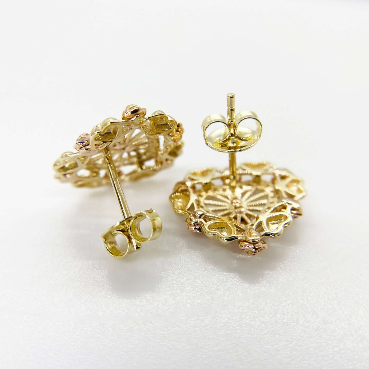 Reverse side of gold Lady of Guadalupe heart stud earrings with secure push-back closures.