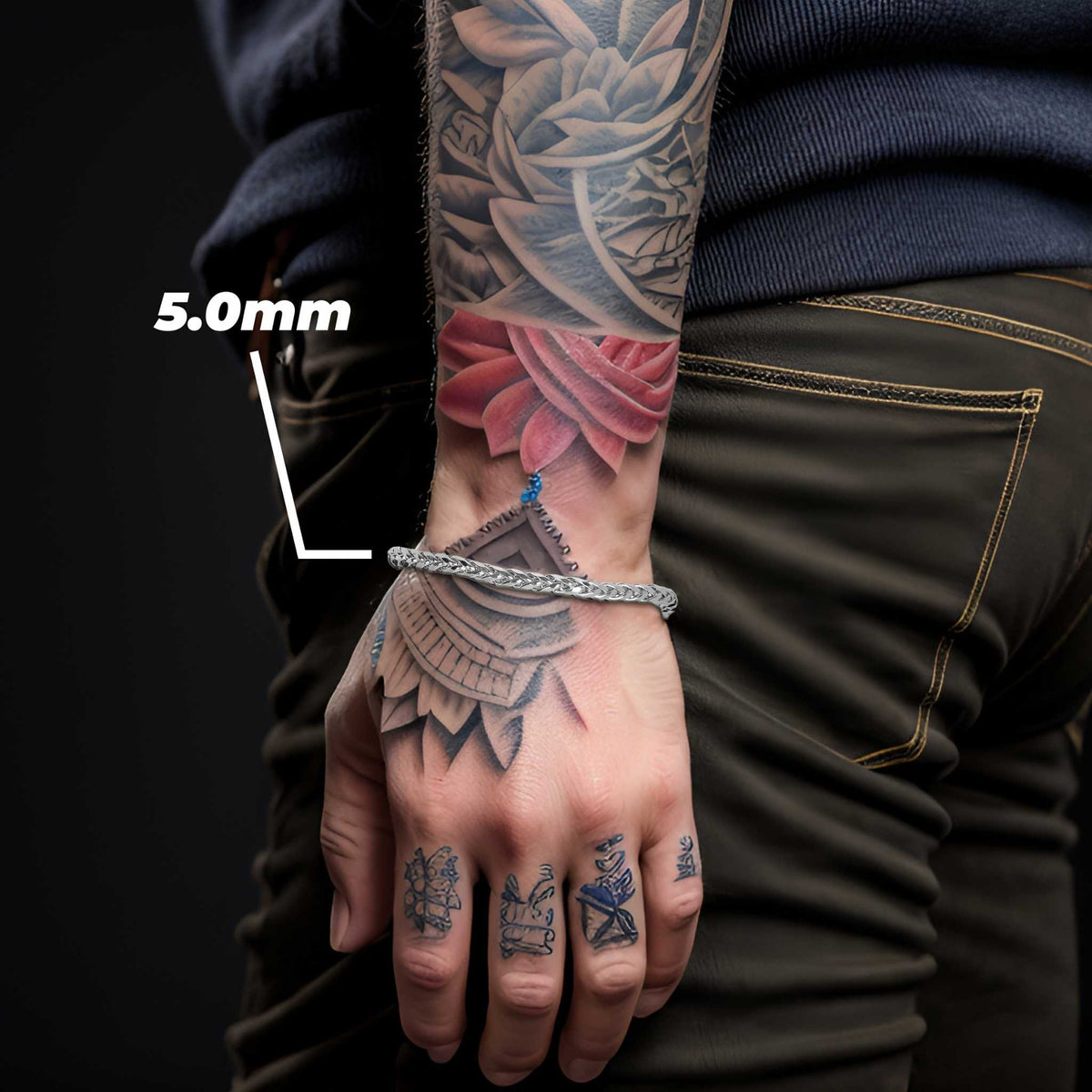 Model wearing a 5.0mm white gold wheat palm chain bracelet on tattooed wrist