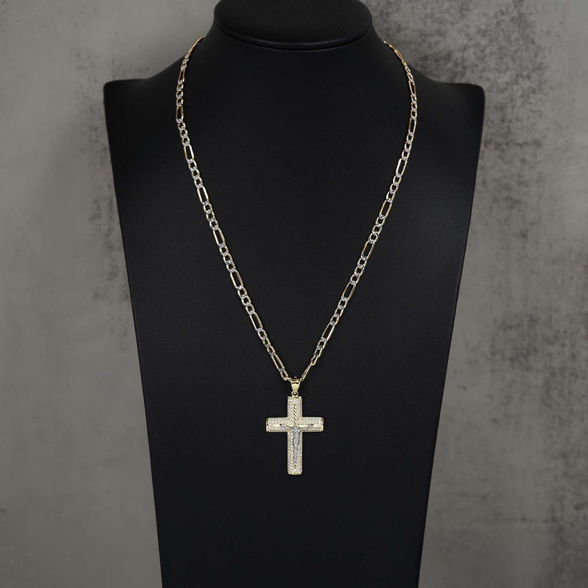 Gold Yelca crucifix CZ pendant necklace displayed on a black mannequin bust.