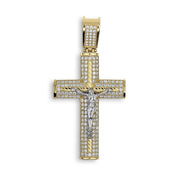 Gold cross pendant encrusted with cubic zirconia, featuring a white gold crucifix center.