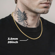 Model wearing a 3.5mm, 20-inch 10k & 14k gold solid classic ice chain over a black shirt.