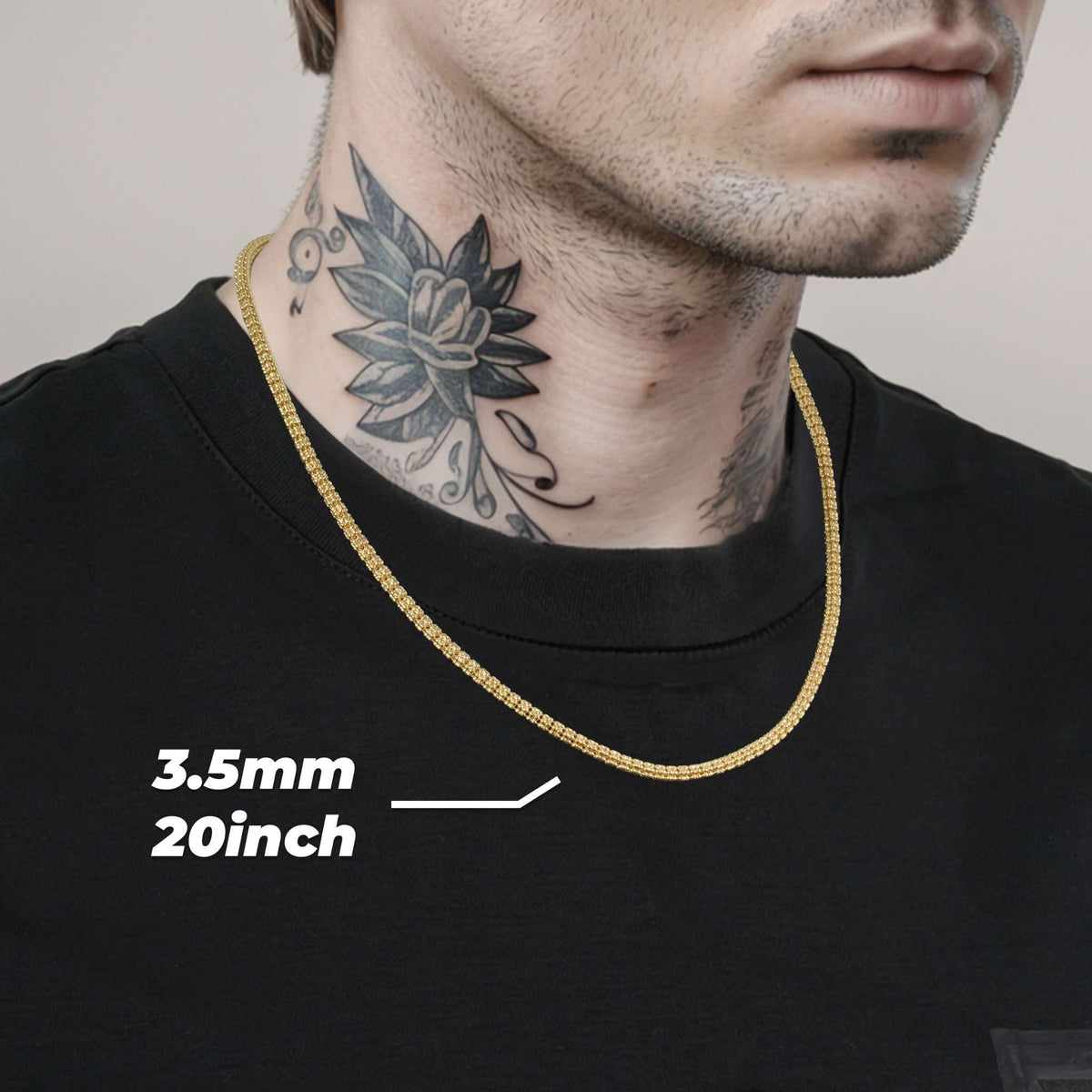 Model wearing a 3.5mm, 20-inch 10k & 14k gold solid classic ice chain over a black shirt.