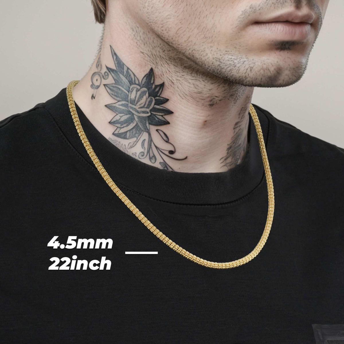 Model wearing a 4.5mm, 22-inch 10k & 14k gold solid classic ice chain over a black shirt.
