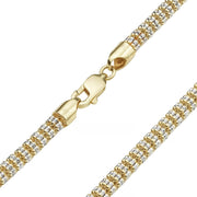 Close-up of a two-tone gold ice chain bracelet with a gold lobster clasp.