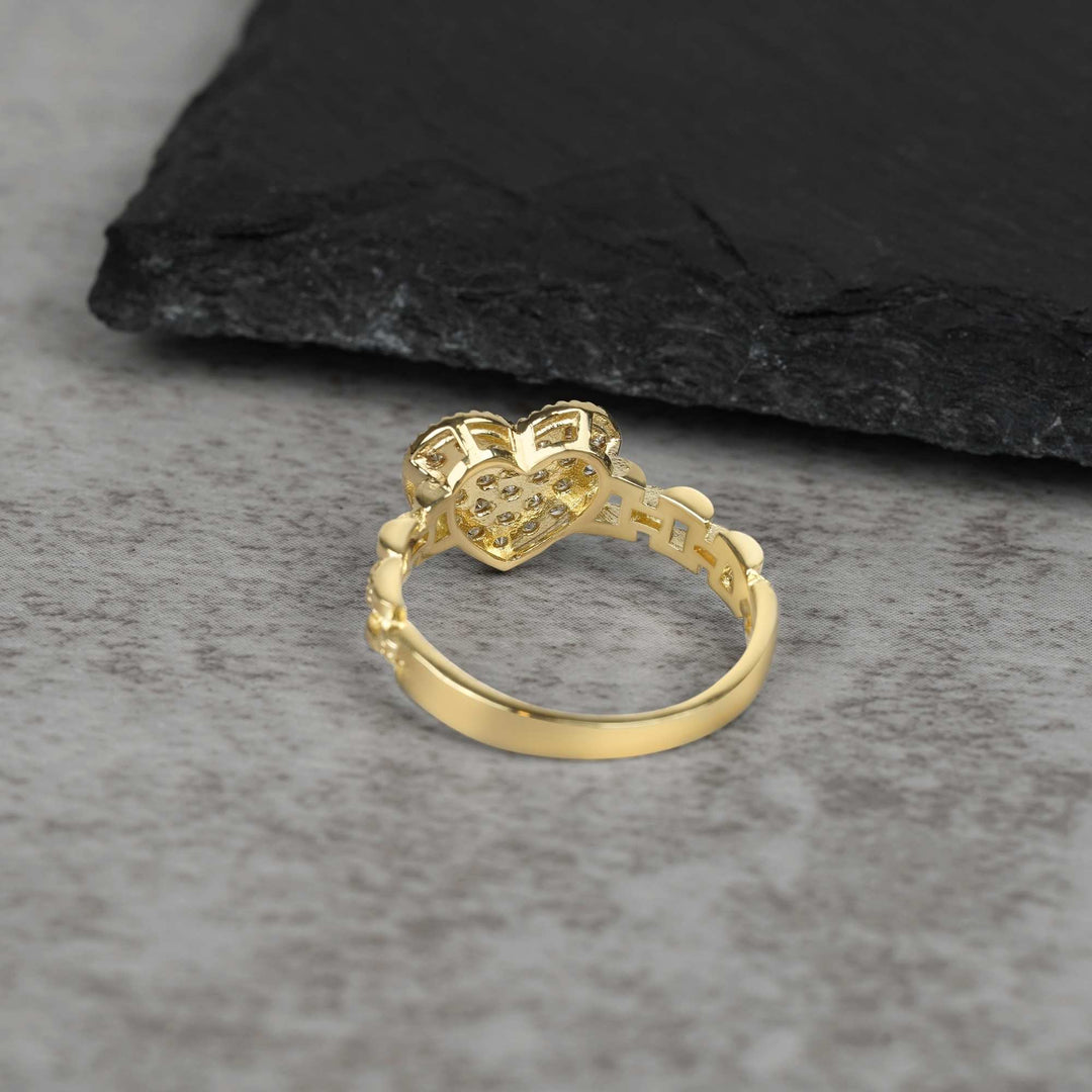 10k Gold heart ring with intricate design on a gray surface back view