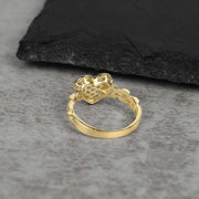 10k Gold heart ring with intricate design on a gray surface back view