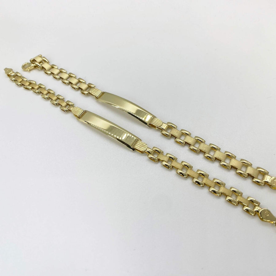 Two 10K yellow gold baby personalized ID Rollie link bracelets laid diagonally