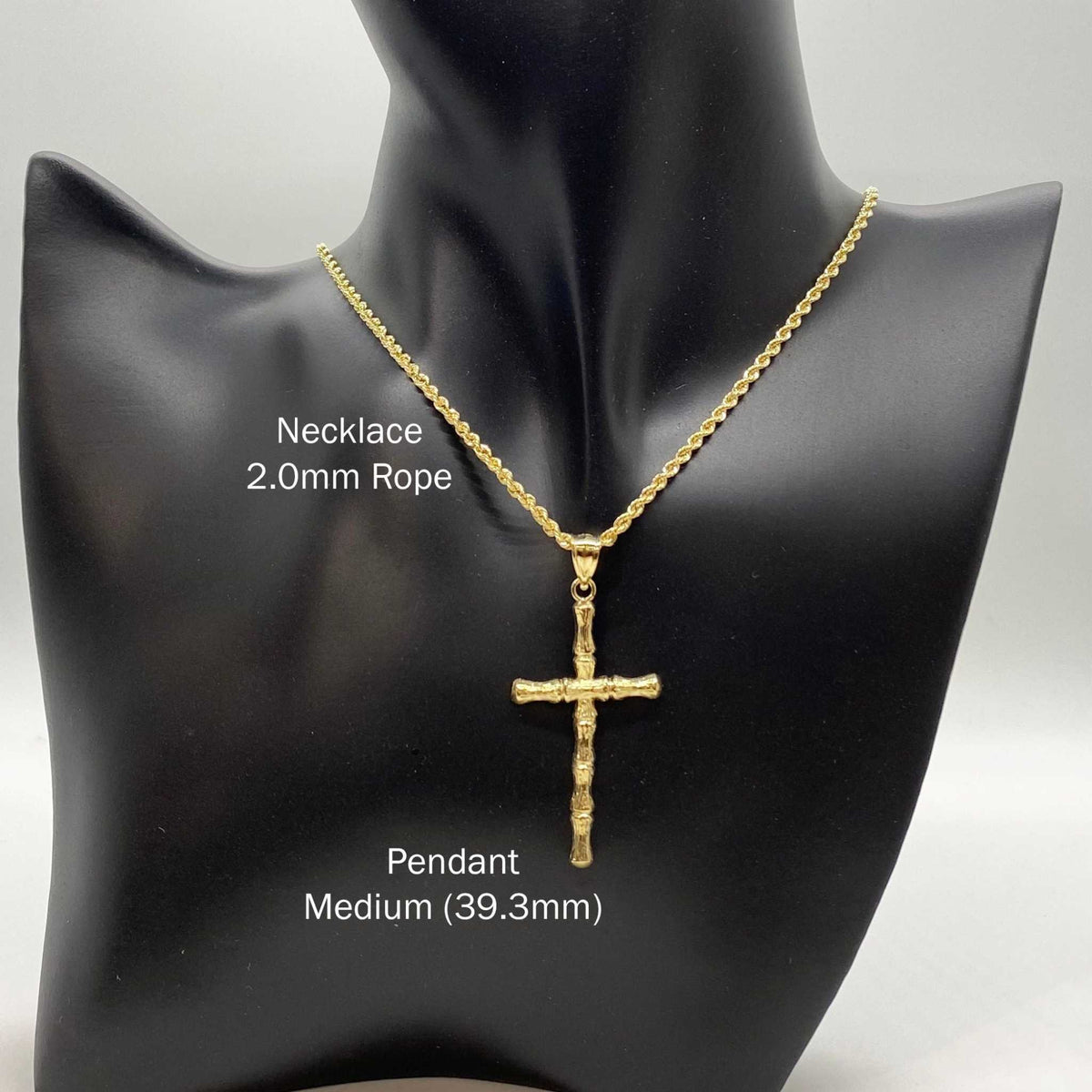 10k yellow gold bamboo cross pendant necklace displayed on a black jewelry mannequin bust.