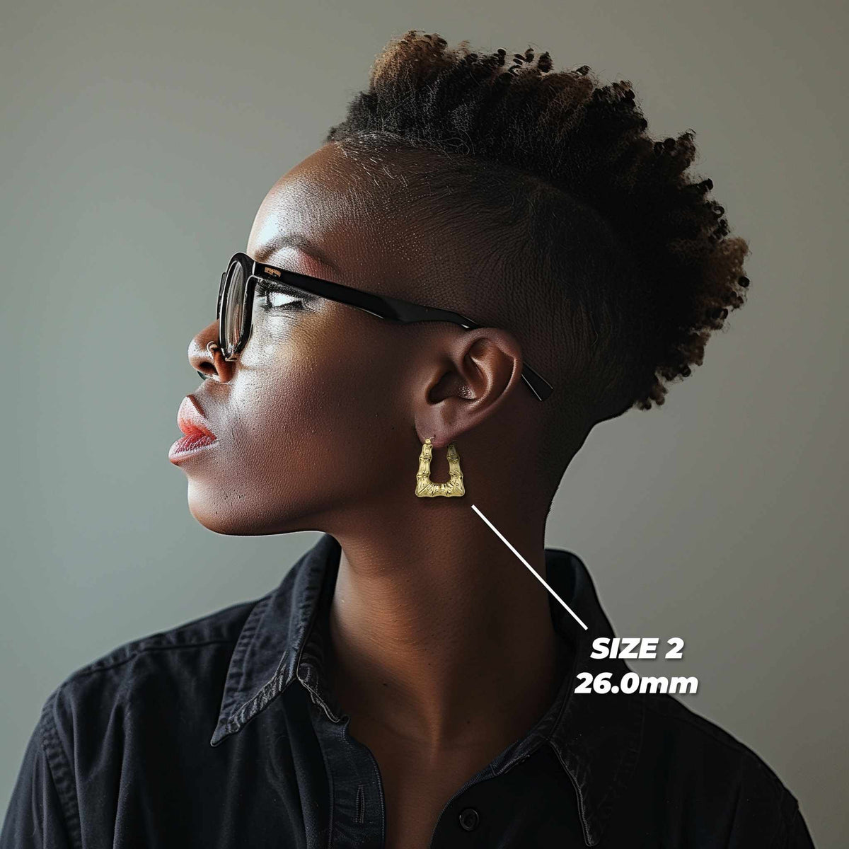 Model wearing a 26.0mm 10k gold bamboo square hoop earring for size reference.