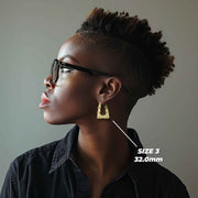 Model wearing a 32.0mm 10k gold bamboo square hoop earring for size reference.