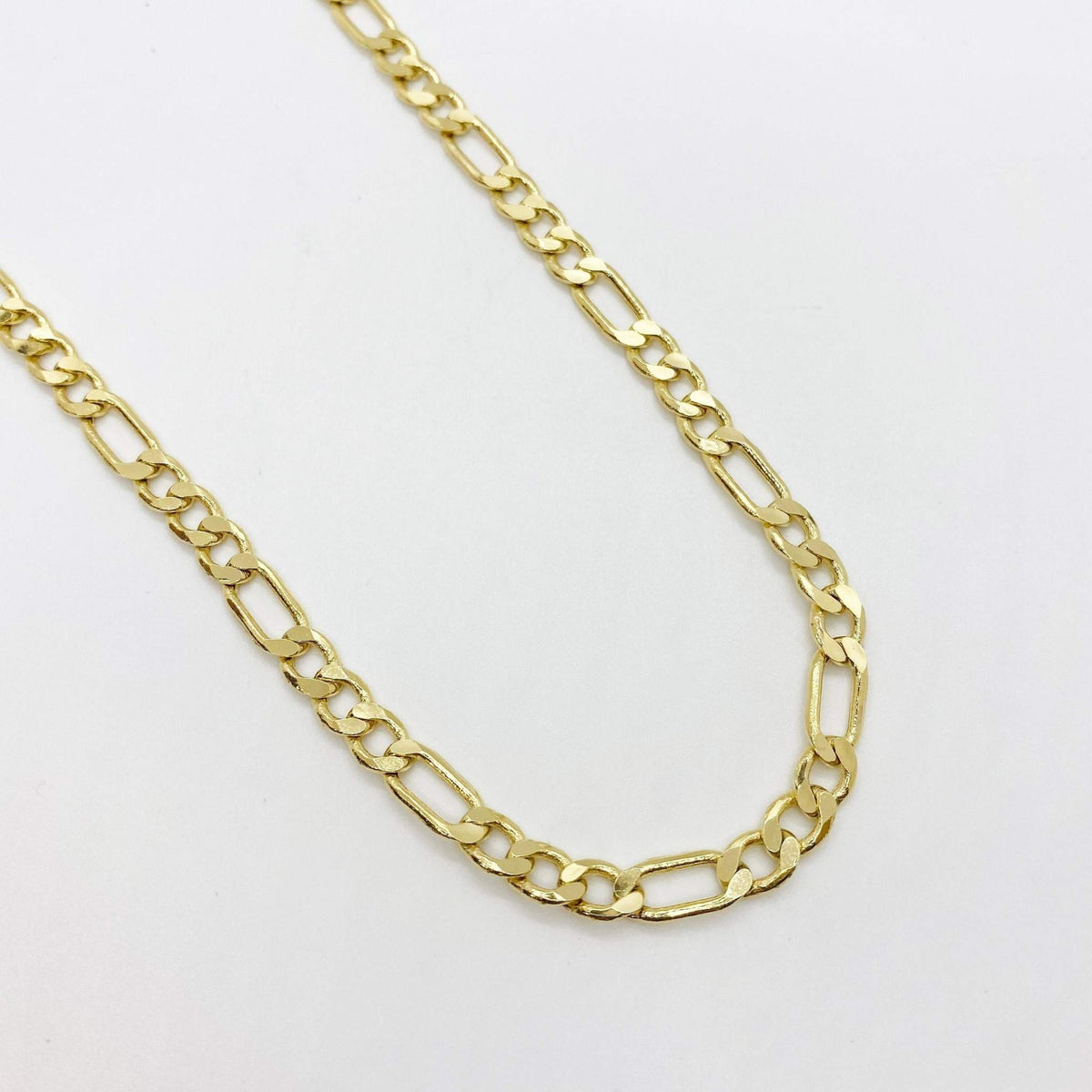 10k yellow gold classic Figaro link chain necklace displayed on white background.