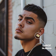 Man wearing a large 14.0mm gold Last Supper rectangular stud earring on his ear.