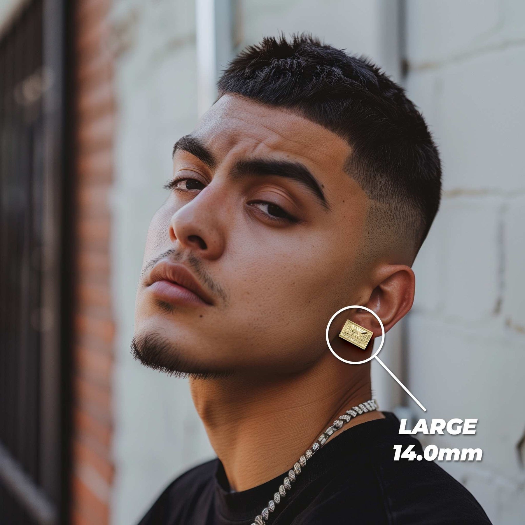 Man wearing a large 14.0mm gold Last Supper rectangular stud earring on his ear.