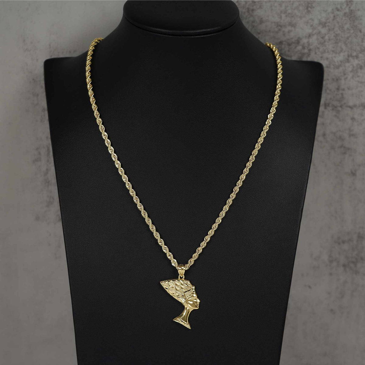 Profile shot of 10k gold Queen Nefertiti pendant necklace on a jewelry bust.