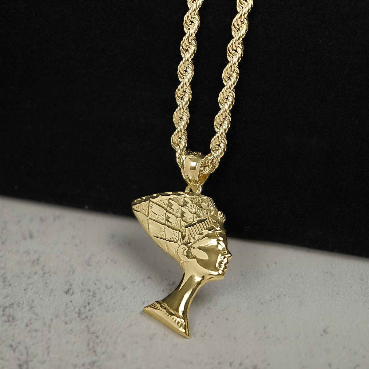 10k yellow gold Queen Nefertiti Egyptian bust pendant charm styled on a gold rope chain.