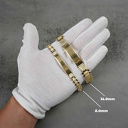 Gloved hand displaying 8.0mm and 14.0mm 10k gold classic Rollie ID bracelets.