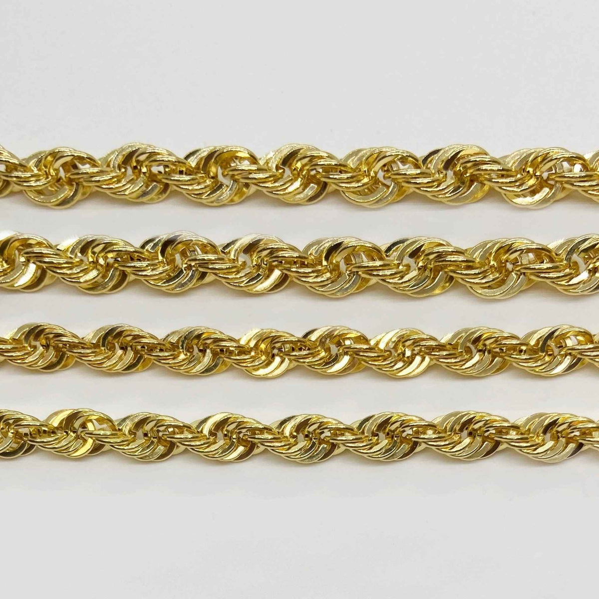 Comparison of 10k yellow gold rope chain link sizes on a plain background.