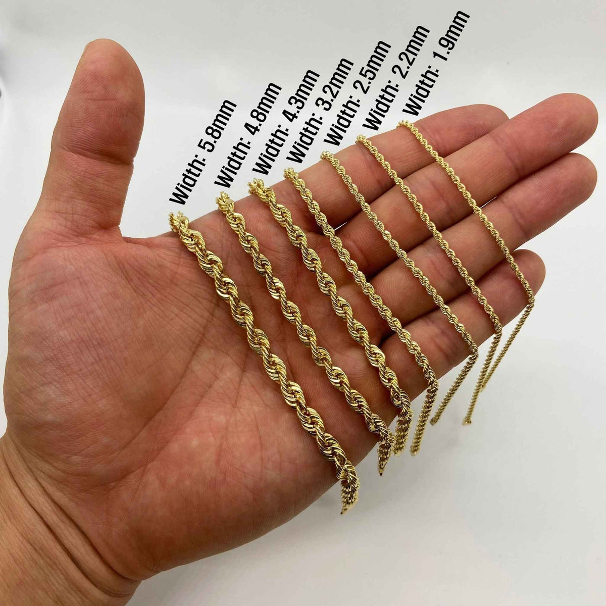 Size comparison of 10k yellow gold rope chains held across a palm.