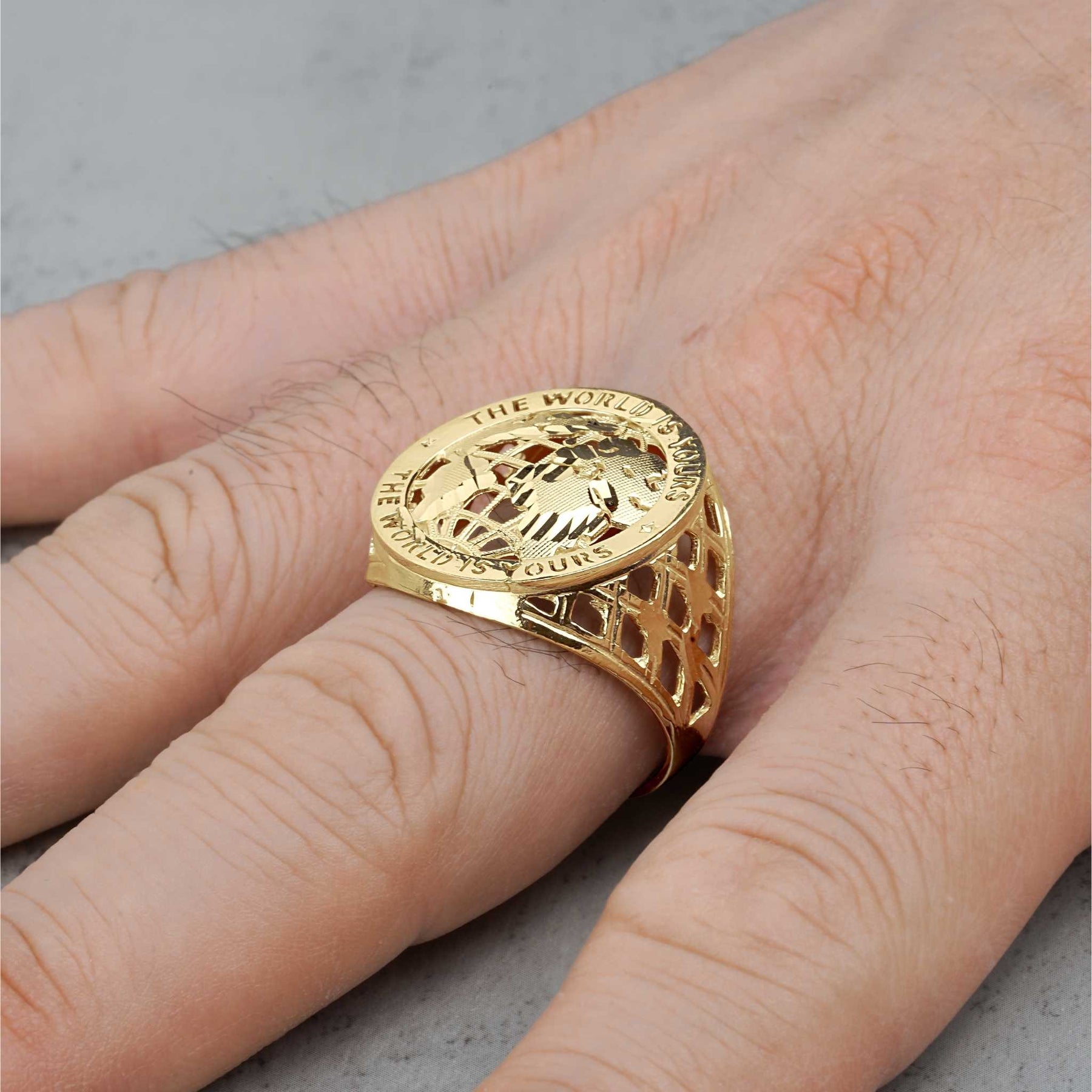10k gold Classic World Is Yours round ring for men on a model's finger.