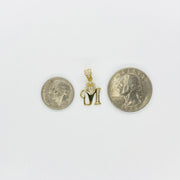 Gold crown initial 'M' pendant placed between two coins for size reference.
