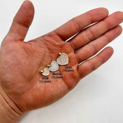 Three 10k gold heart pendants held in hand with size labels in millimeters.